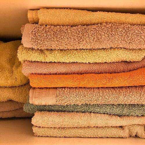 In the kitchen -  Use an old towel to make rags instead of buying single-use paper towels